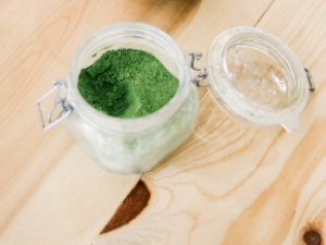 green powder in a glass container